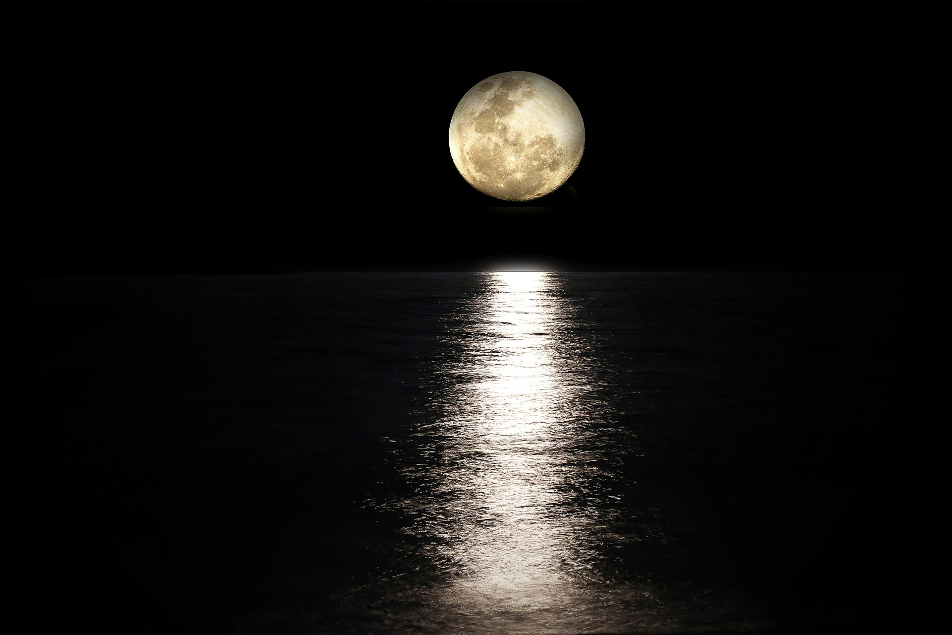 the moon reflecting over water