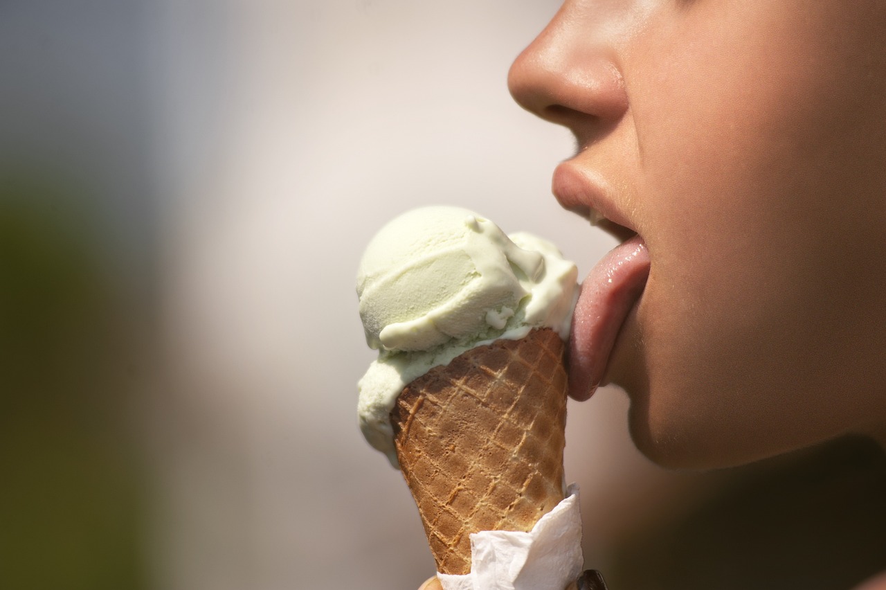 a girl licking an ice cream