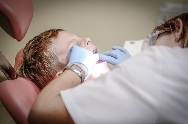 boy being examined by dentist