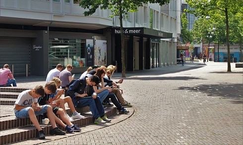 young adults sitting on fountain base