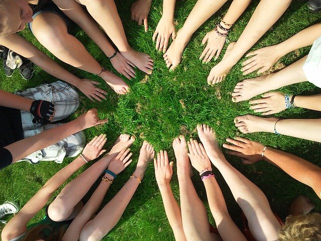 many people forming a cicle with their feet